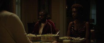 Movie still from “Queen & Slim” (2019), directed by Melina Matsoukas – Two people sitting at a table with a bowl of food; Medium shot, Over the shoulder angle