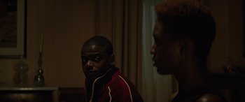 Movie still from “Queen & Slim” (2019), directed by Melina Matsoukas – A man and a woman are standing in front of a window; Medium shot, Over the shoulder angle
