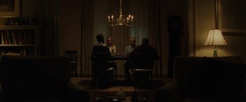 Movie still from “Queen & Slim” (2019), directed by Melina Matsoukas – A group of people sitting at a table in front of a chandelier; Wide shot, Low angle
