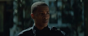 Movie still from “Queen & Slim” (2019), directed by Melina Matsoukas – A man in a police uniform looking at the camera; Close Up shot, Low angle