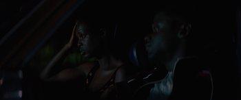 Movie still from “Queen & Slim” (2019), directed by Melina Matsoukas – A man and a woman sitting in a car at night; Close Up shot, High angle