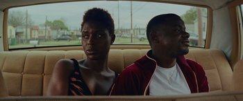 Movie still from “Queen & Slim” (2019), directed by Melina Matsoukas – A man and a woman sitting in the back of a car; Close Up shot, Over the shoulder angle