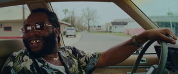 Movie still from “Queen & Slim” (2019), directed by Melina Matsoukas – A man driving a car on a street; Close Up shot, Over the shoulder angle