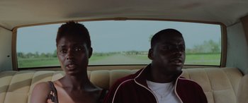 Movie still from “Queen & Slim” (2019), directed by Melina Matsoukas – Two people sitting in a car looking out the window; Close Up shot, Over the shoulder angle