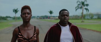 Movie still from “Queen & Slim” (2019), directed by Melina Matsoukas – A man and a woman standing next to each other on the side of a road; Close Up shot, Low angle