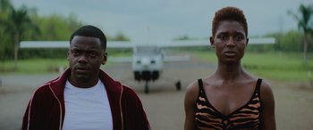 Movie still from “Queen & Slim” (2019), directed by Melina Matsoukas – A man and a woman standing next to each other in front of an airplane; Close Up shot, Low angle