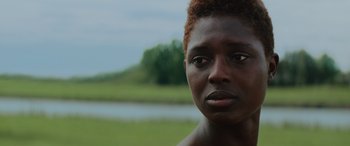 Movie still from “Queen & Slim” (2019), directed by Melina Matsoukas – A person with a river in the background; Close Up shot, Over the shoulder angle