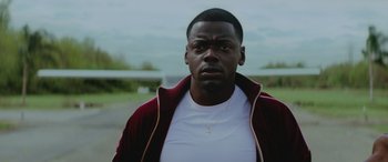 Movie still from “Queen & Slim” (2019), directed by Melina Matsoukas – A person wearing a white t shirt; Close Up shot, Low angle