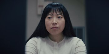 Movie still from “Quiz Lady” (2023), directed by Jessica Yu – A person with long black hair; Close Up shot, Low angle