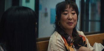 Movie still from “Quiz Lady” (2023), directed by Jessica Yu – A woman sitting in front of another woman; Close Up shot, Over the shoulder angle