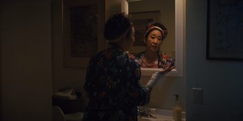 Movie still from “Quiz Lady” (2023), directed by Jessica Yu – A woman is looking in the mirror in the bathroom; Close Up shot, Over the shoulder angle