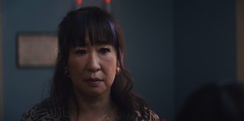 Movie still from “Quiz Lady” (2023), directed by Jessica Yu – A person with long black hair; Close Up shot, Over the shoulder angle