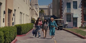 Movie still from “Quiz Lady” (2023), directed by Jessica Yu – A group of women walking down a street; Wide shot, High angle