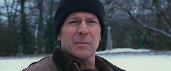 Movie still from “RED” (2010), directed by Robert Schwentke – A person wearing a hat; Close Up shot, Low angle