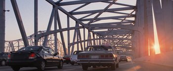 Movie still from “RED” (2010), directed by Robert Schwentke – Cars are driving on a bridge over a river; Extreme Wide shot, Low angle