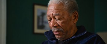 Movie still from “RED” (2010), directed by Robert Schwentke – An older man is looking down at his face; Close Up shot, Low angle