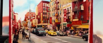 Movie still from “RED” (2010), directed by Robert Schwentke – A busy city street filled with cars and buildings; Extreme Wide shot, High angle
