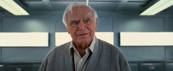 Movie still from “RED” (2010), directed by Robert Schwentke – An older man with white hair wearing a gray sweater; Close Up shot, Low angle