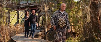 Movie still from “RED” (2010), directed by Robert Schwentke – Two men walking down a path with a rifle; Wide shot, Over the shoulder angle