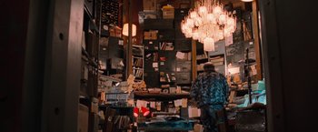 Movie still from “RED” (2010), directed by Robert Schwentke – A man standing in front of a room filled with lots of boxes; Wide shot, Low angle