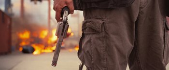 Movie still from “RED” (2010), directed by Robert Schwentke – A man holding a gun in his right hand; Medium shot, Low angle