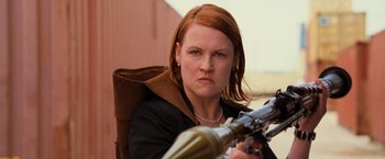 Movie still from “RED” (2010), directed by Robert Schwentke – A woman holding a gun while sitting in a chair; Close Up shot, Low angle