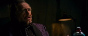 Movie still from “RED” (2010), directed by Robert Schwentke – An older man wearing a purple jacket and a black shirt; Close Up shot, Low angle