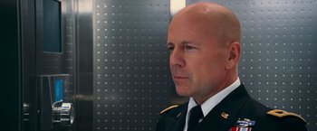 Movie still from “RED” (2010), directed by Robert Schwentke – A man in a military uniform looking to his left; Close Up shot, Low angle