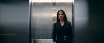 Movie still from “RED” (2010), directed by Robert Schwentke – A woman standing in front of an elevators door; Medium shot, Low angle