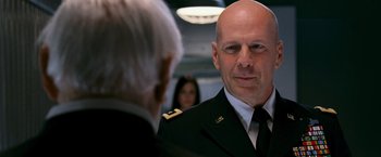 Movie still from “RED” (2010), directed by Robert Schwentke – A man in a military uniform talking to another man; Close Up shot, Over the shoulder angle