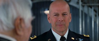 Movie still from “RED” (2010), directed by Robert Schwentke – A man in a military uniform is looking at the camera; Close Up shot, Over the shoulder angle