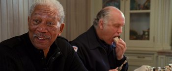 Movie still from “RED” (2010), directed by Robert Schwentke – Two older men sitting at a table eating food; Close Up shot, Over the shoulder angle