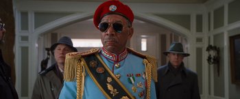 Movie still from “RED” (2010), directed by Robert Schwentke – An older man in a military uniform wearing a red hat; Close Up shot, Low angle