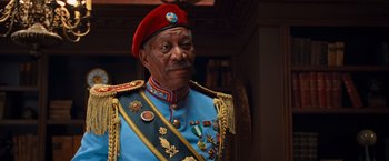 An older man in a military uniform wearing a red hat