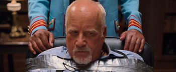 Movie still from “RED” (2010), directed by Robert Schwentke – An older man sitting in front of a mirror; Close Up shot, Over the shoulder angle