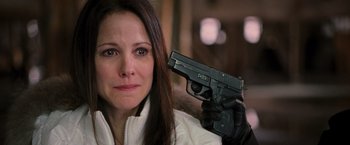 Movie still from “RED” (2010), directed by Robert Schwentke – A woman is holding a gun in her hand; Close Up shot, Over the shoulder angle