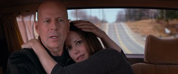 Movie still from “RED” (2010), directed by Robert Schwentke – A man and a woman in the back seat of a car; Close Up shot, Over the shoulder angle