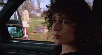 Movie still from “Rain Man” (1988), directed by Barry Levinson – A woman sitting in the back of a car looking out the window; Close Up shot, Over the shoulder angle