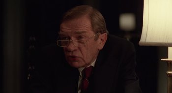 Movie still from “Rain Man” (1988), directed by Barry Levinson – An older man wearing glasses and a suit; Close Up shot, Over the shoulder angle