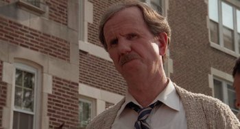 Movie still from “Rain Man” (1988), directed by Barry Levinson – An older man wearing a tie standing in front of a brick building; Close Up shot, Low angle