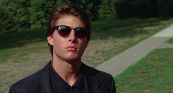Movie still from “Rain Man” (1988), directed by Barry Levinson – A young man wearing sunglasses and a black suit; Close Up shot, Low angle