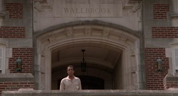 Movie still from “Rain Man” (1988), directed by Barry Levinson – A man standing in front of an archway with the name wallbrook on it; Wide shot, Low angle