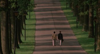 Movie still from “Rain Man” (1988), directed by Barry Levinson – Two people walking down a street holding hands; Extreme Wide shot, High angle