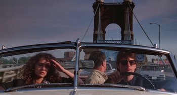 Movie still from “Rain Man” (1988), directed by Barry Levinson – A group of people in the back seat of a car; Wide shot, Over the shoulder angle