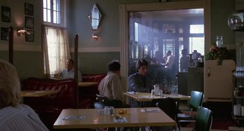 Movie still from “Rain Man” (1988), directed by Barry Levinson – People are sitting at tables in a restaurant; Wide shot, Over the shoulder angle