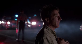 Movie still from “Rain Man” (1988), directed by Barry Levinson – A man standing on the side of a road at night; Close Up shot, Over the shoulder angle