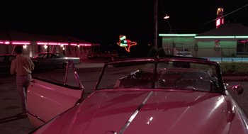 Movie still from “Rain Man” (1988), directed by Barry Levinson – A car parked on the side of the road at night; Extreme Wide shot, Low angle