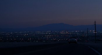 Movie still from “Rain Man” (1988), directed by Barry Levinson – A car driving down a street at night; Extreme Wide shot, High angle