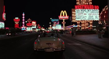 Movie still from “Rain Man” (1988), directed by Barry Levinson – A car driving down a street at night; Extreme Wide shot, High angle