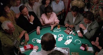 Movie still from “Rain Man” (1988), directed by Barry Levinson – A group of people sitting around a table playing poker; Wide shot, High angle